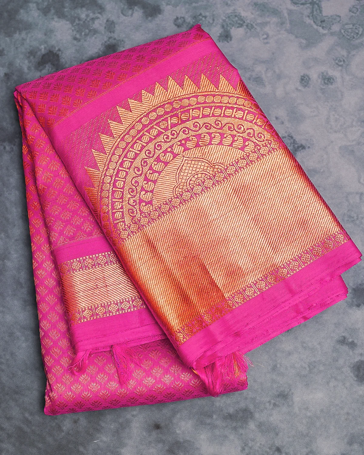 Magenta pure silk saree with a lustrous drape and an ornate gold woven pallu